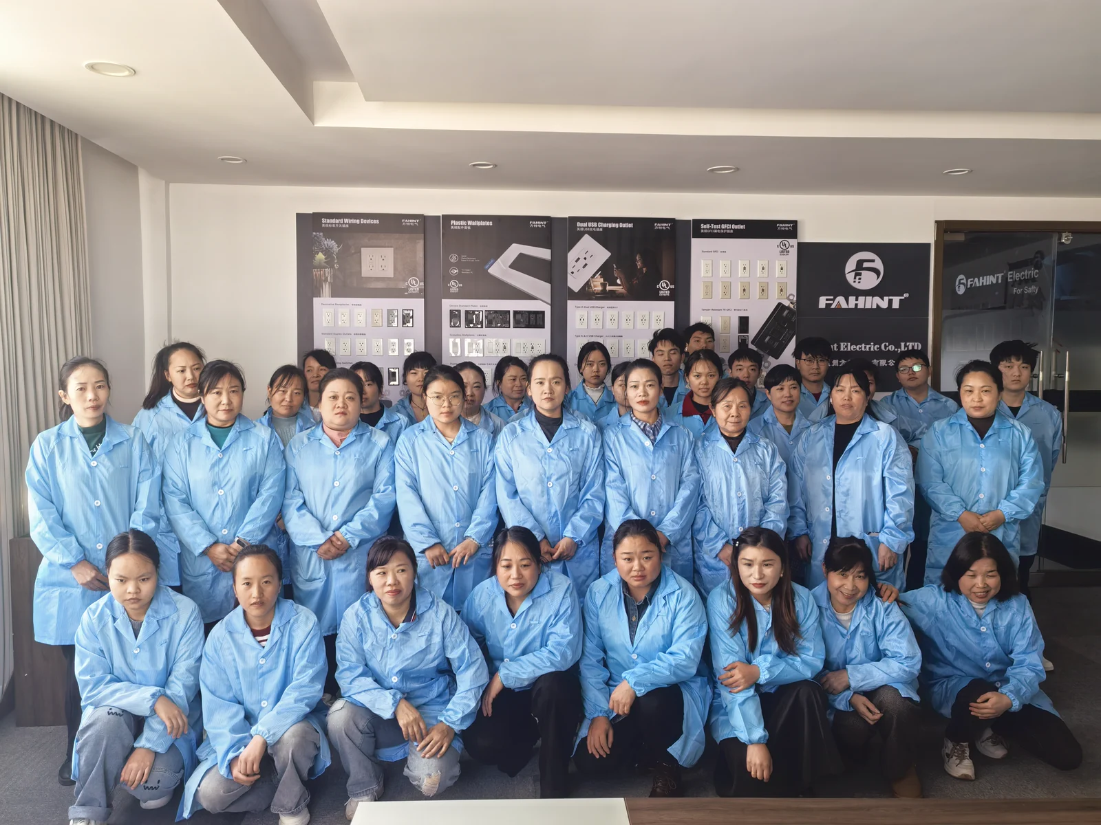 The FAHINT team in front of the company product display